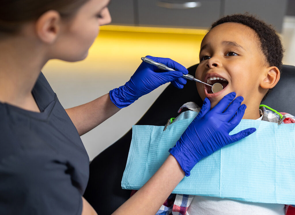 Insurance by Industry - Dentist Giving a Boy a Dental Exam During an Appointment