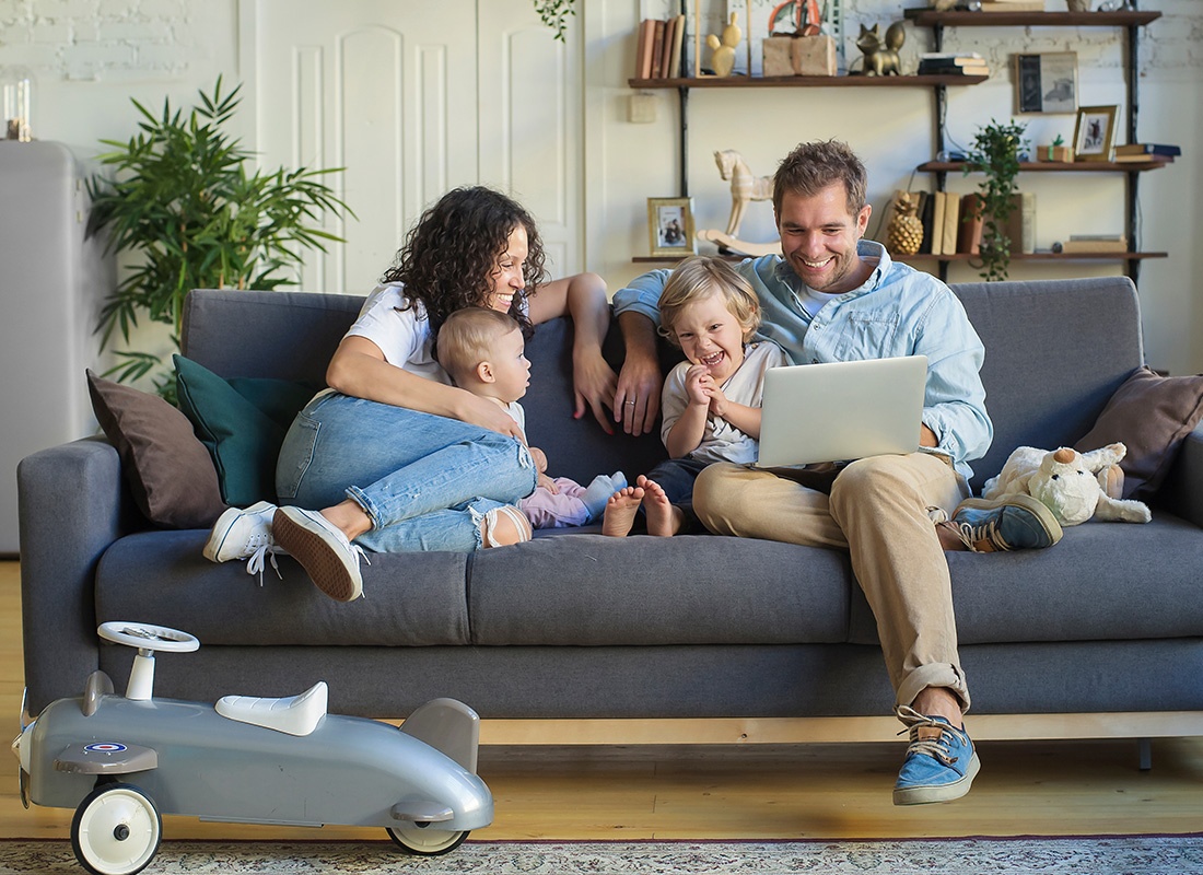 Personal Insurance - Happy Family Sitting Together at Home